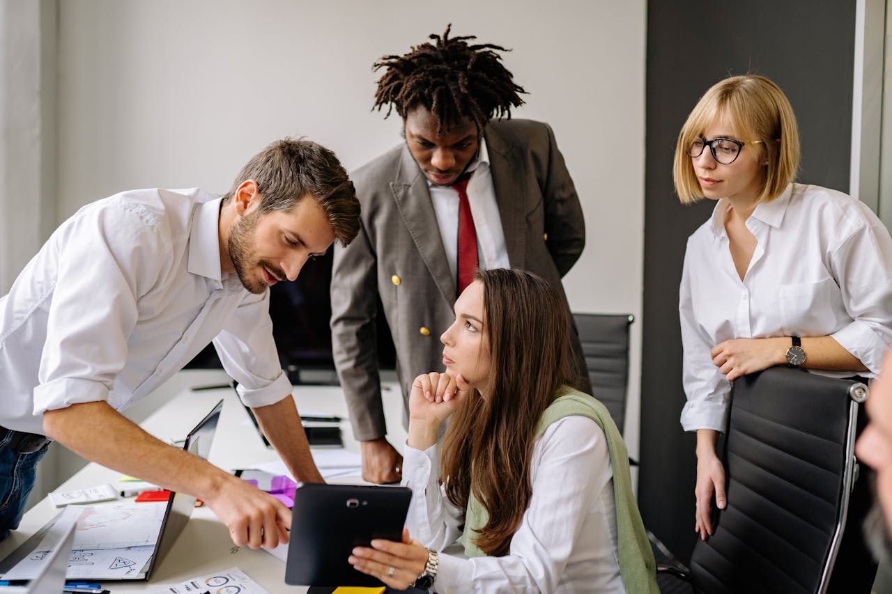 A group of professionals engaging in a collaborative business meeting in a modern office.